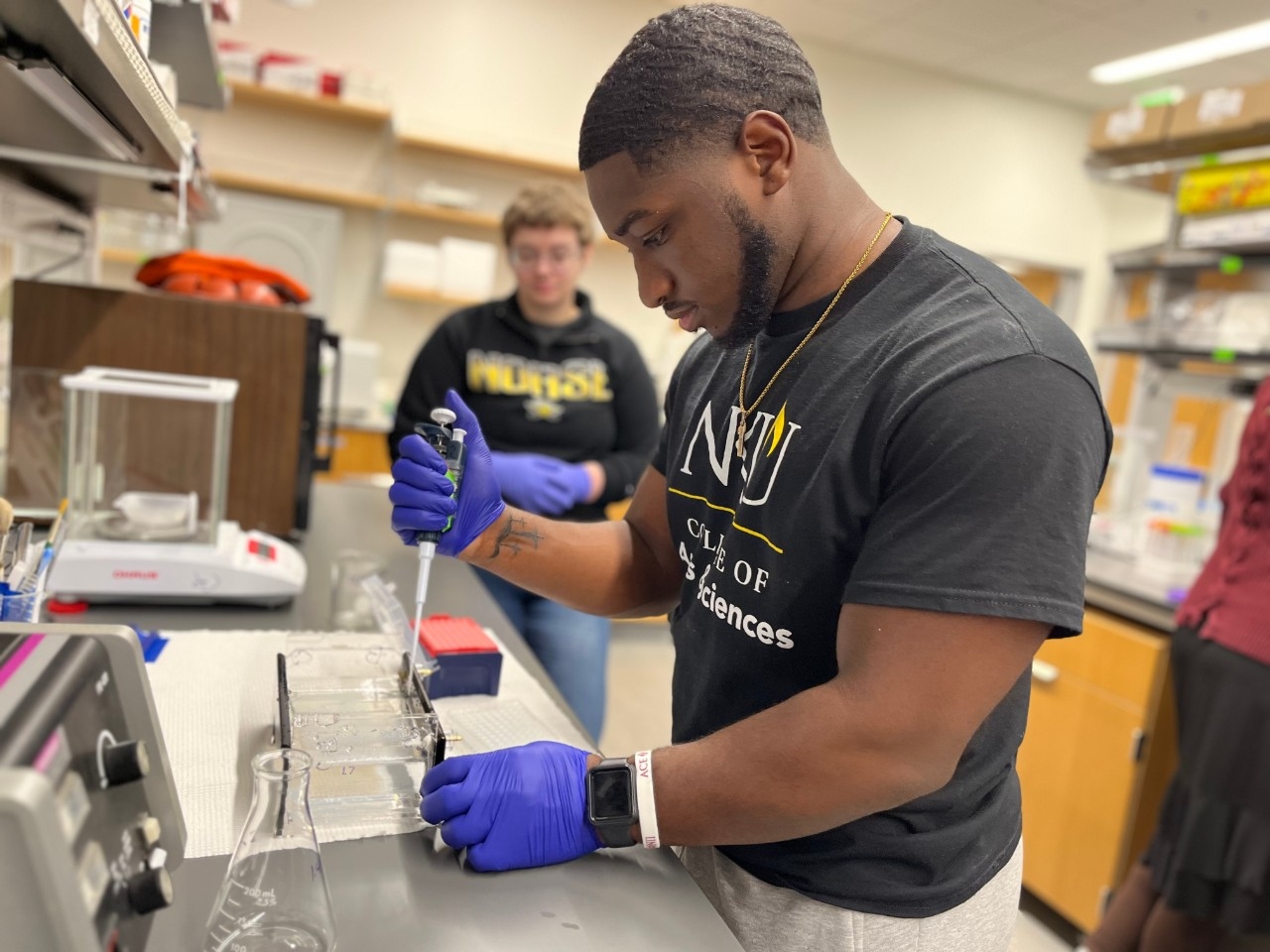 Biology student using a pipette in the lab