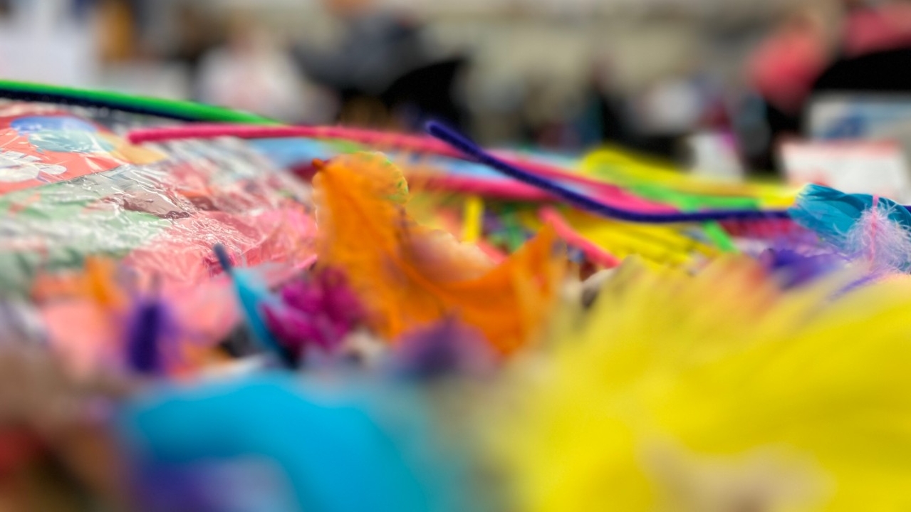 An array of colorful craft supplies on a table.