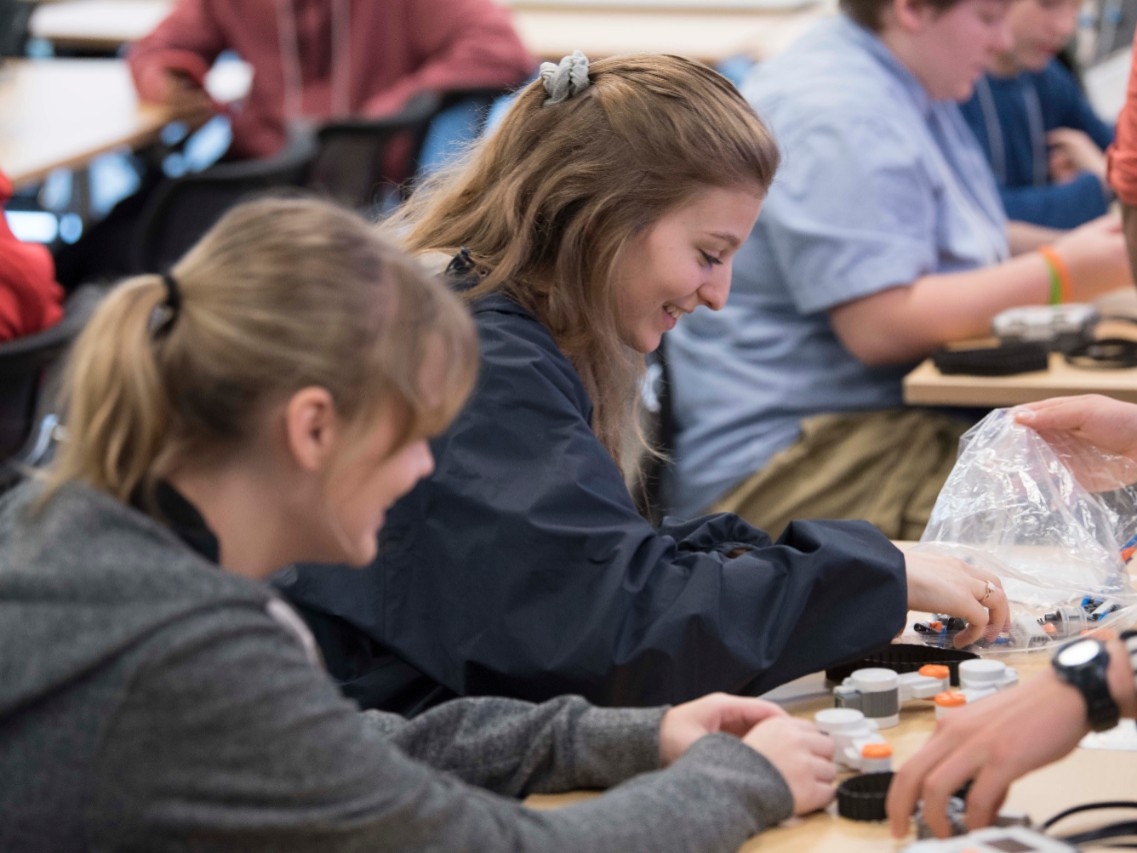 High school students enjoying an engineering activity at High School STEM+H Day event.