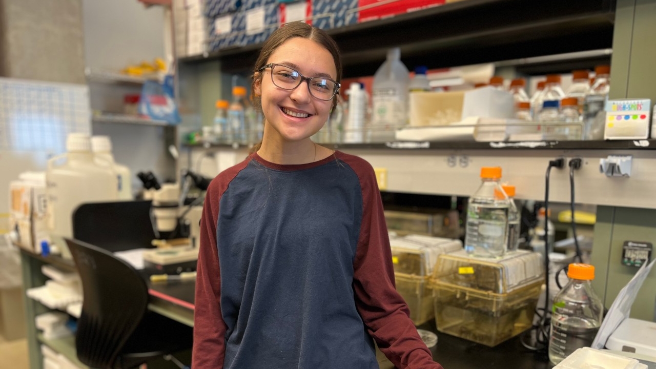 NKU Biology major and scholarship recipient smiles for the camera in the lab during research.