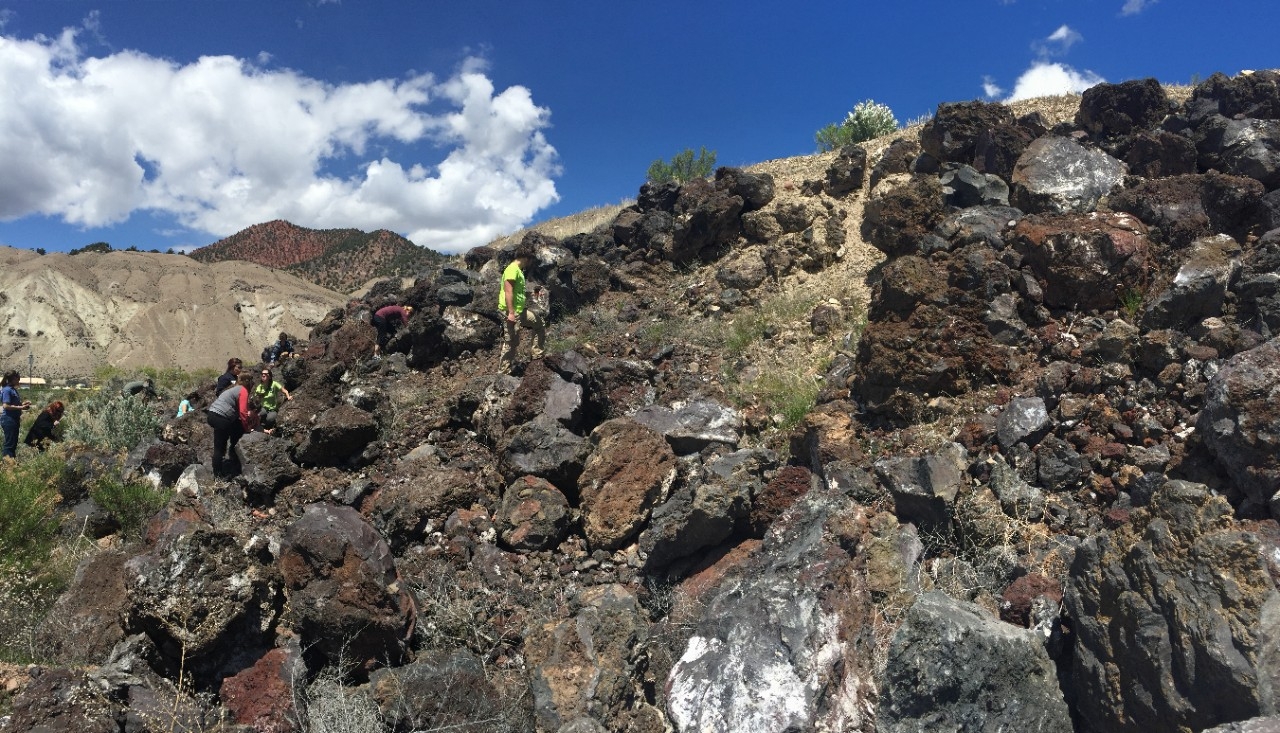 Students walking over a rocky, irregular landscape