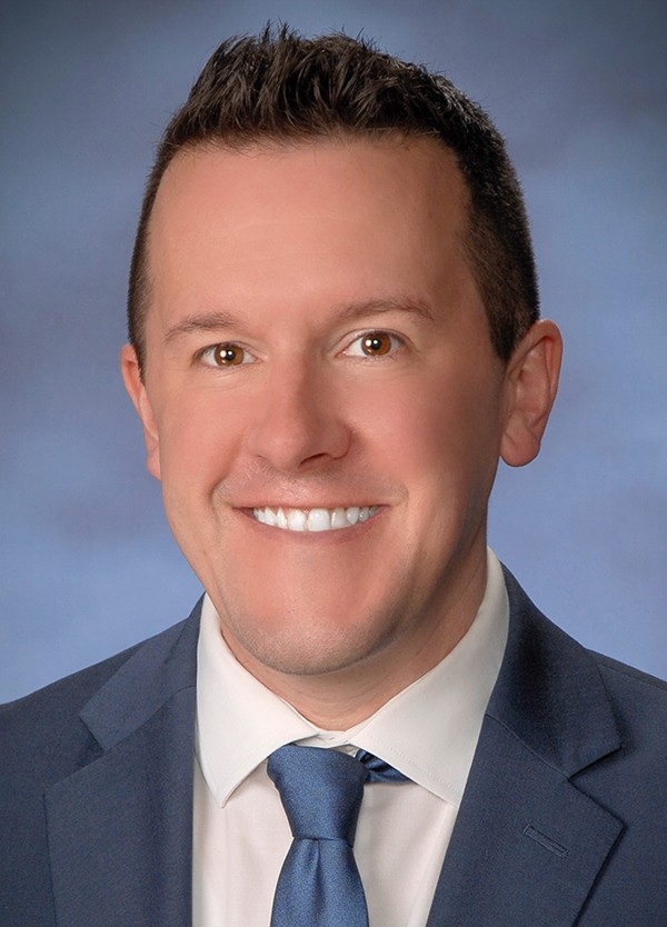 Tom Haggard headshot and 40 under 40 logo
