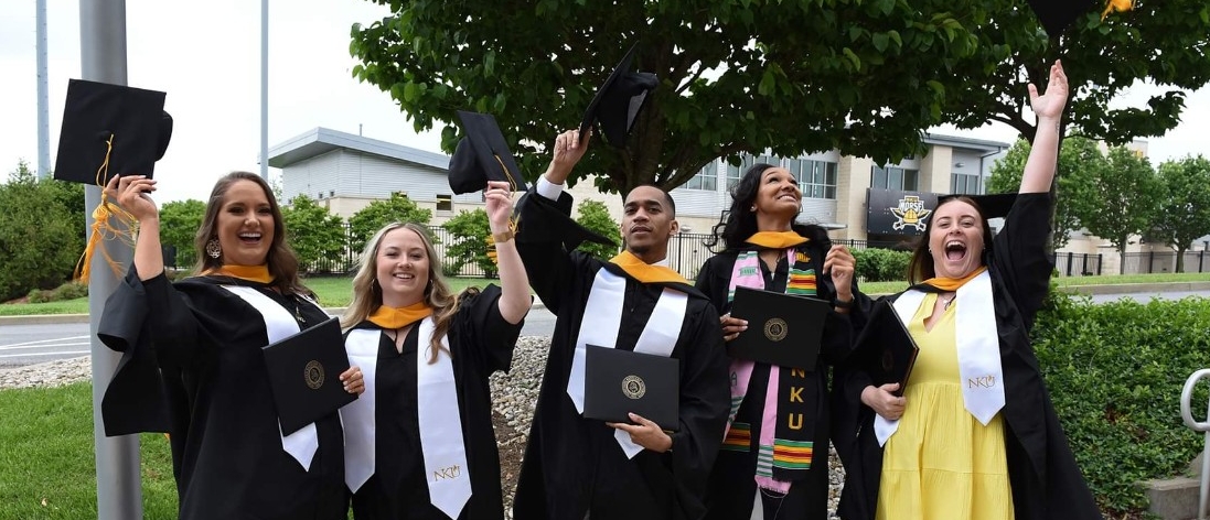 Graduates with diplomas