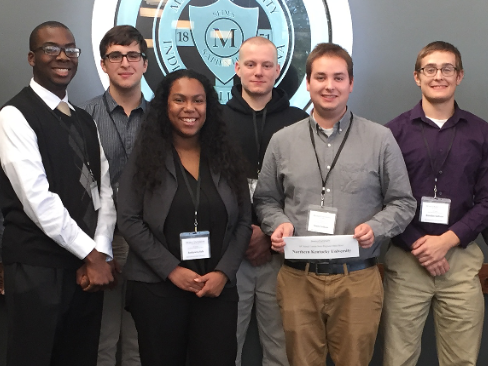 Group of students at a conference posing.