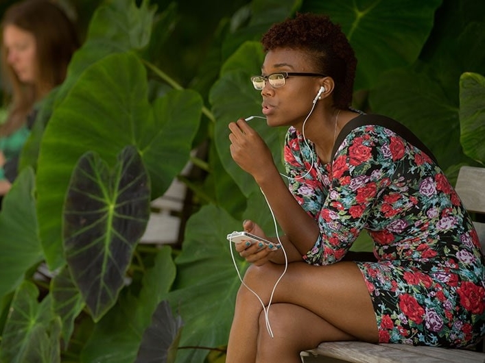 Young woman listening to music outdoors