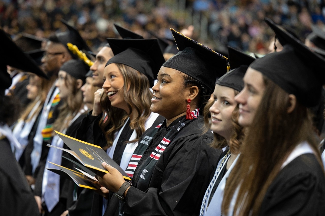 Students smiling at graduation