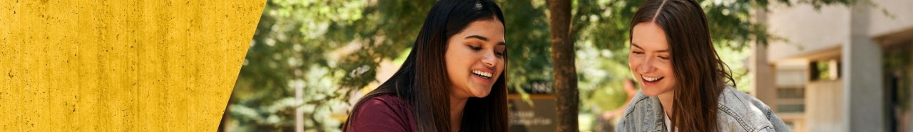 Two students smiling outdoors