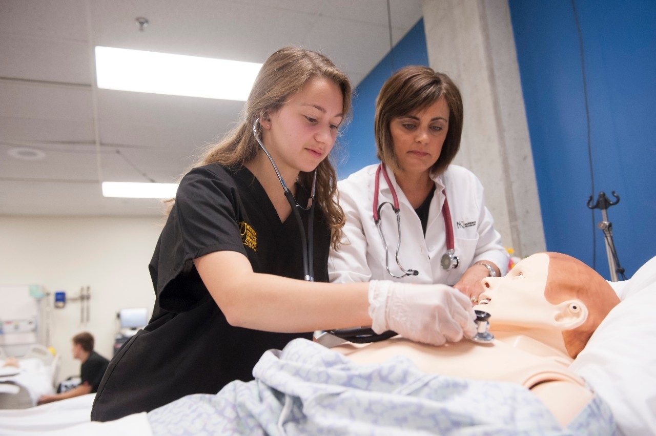 Preceptor works with a student