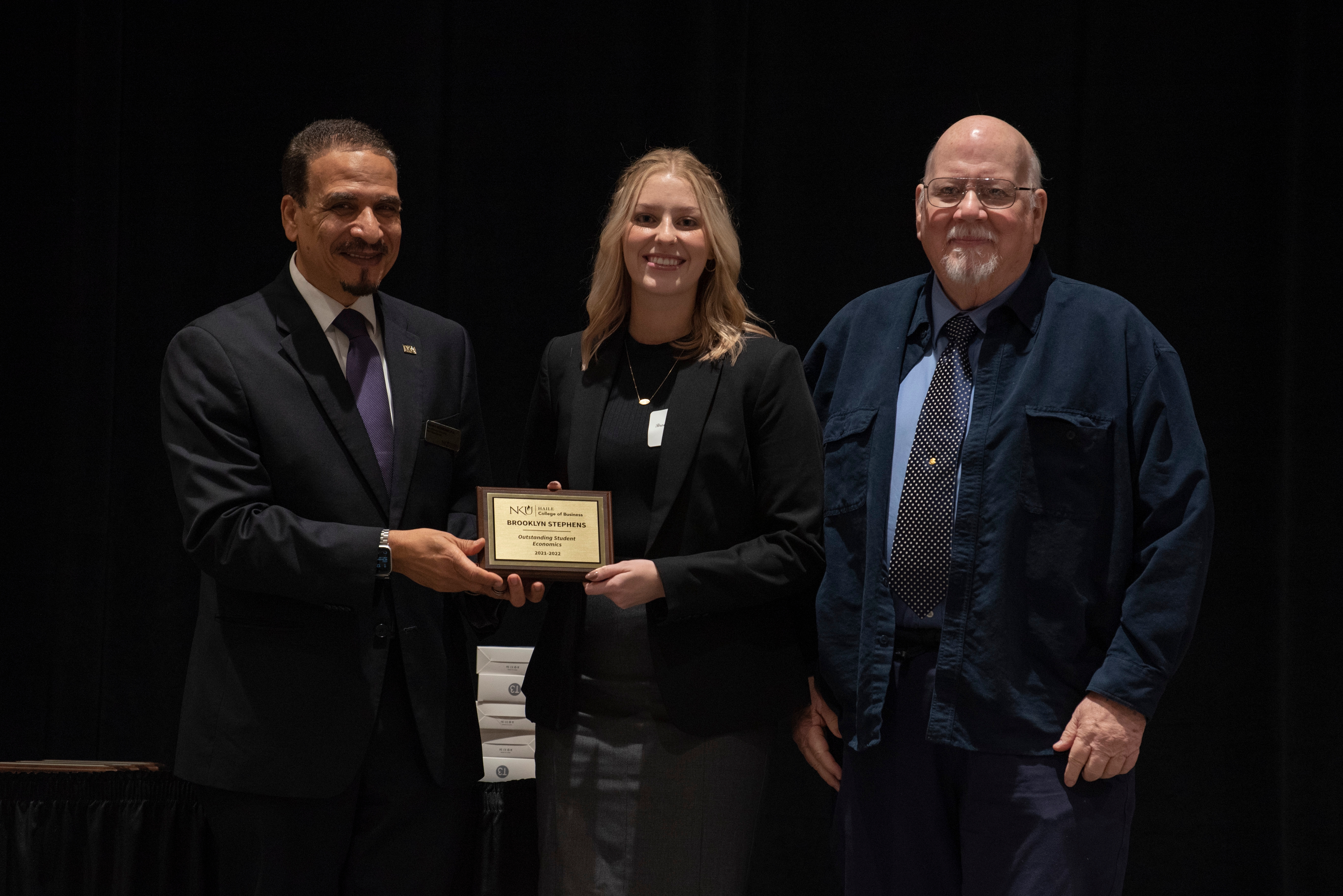 Brooklyn Stephens pictured with Dean Hassan HassabElnaby and Department Chair Gary Clayton