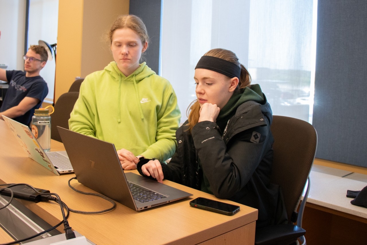 Students working on laptops in classroom