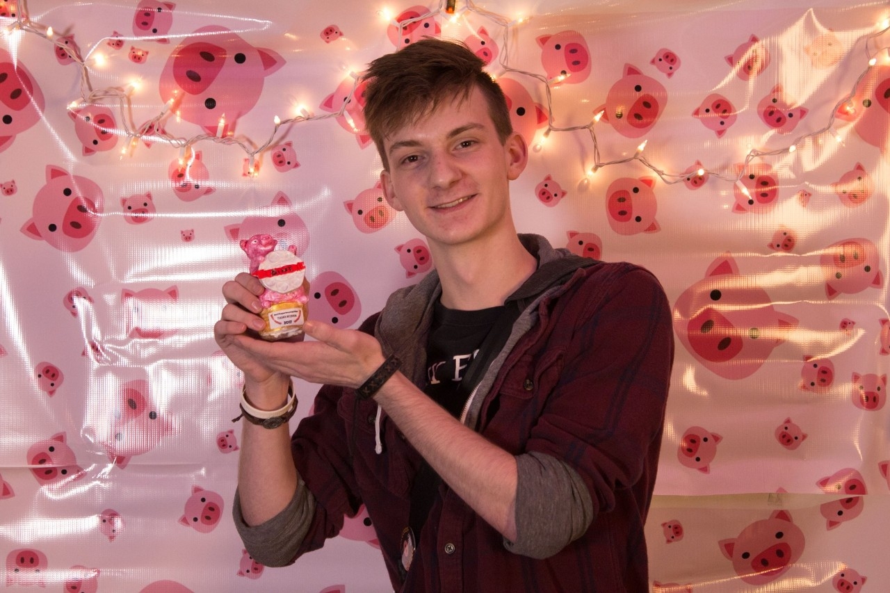 Image of an OINK film festival participant holding a winning trophy.