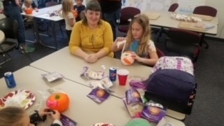 Student parent with child doing crafts