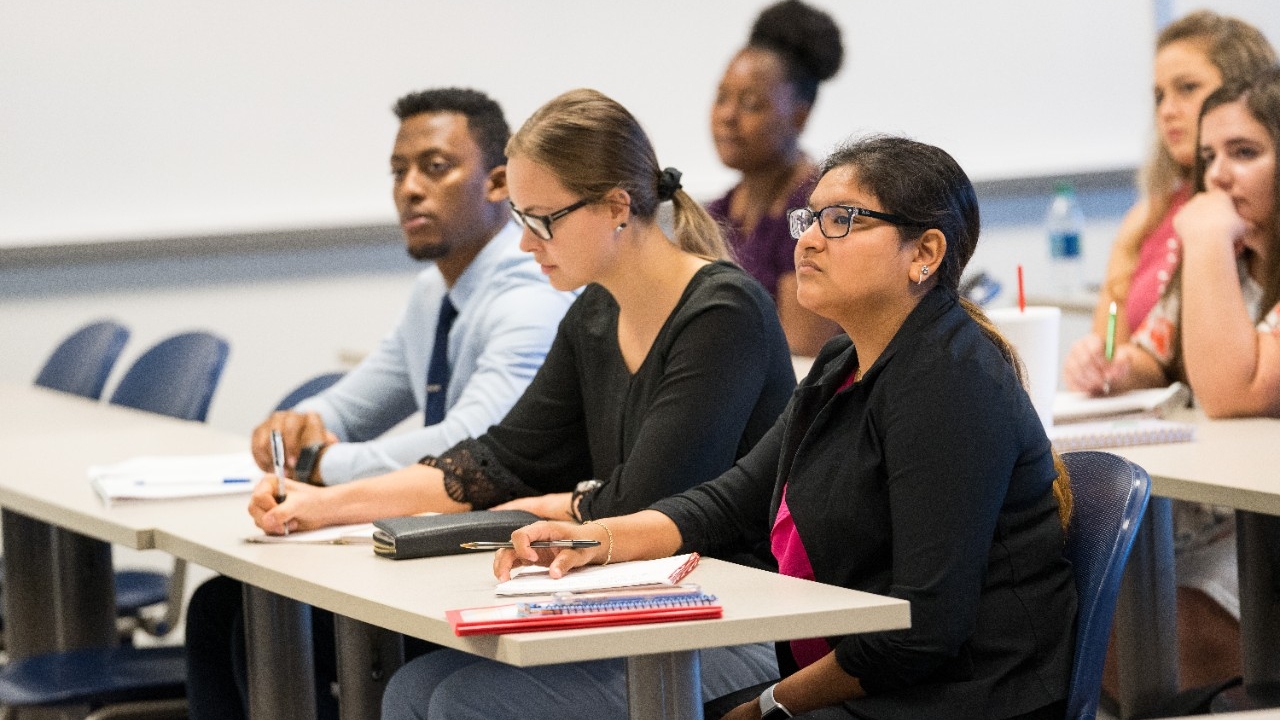 Students listen to a lecture in the College of Business