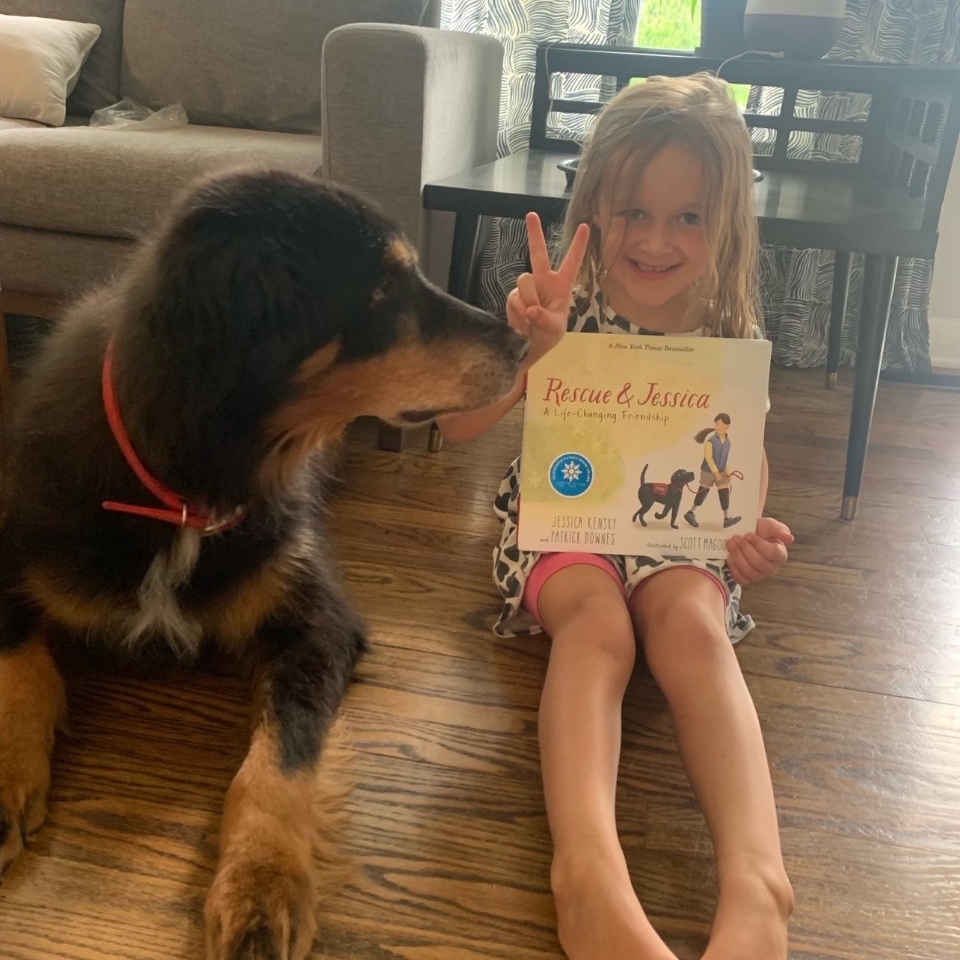 A child holds a book from the Health Science Book Club